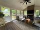 The sunroom features a fireplace, natural light, lots of windows, and comfortable seating at 747 Dogwood Cir, Norcross, GA 30071