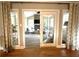 The sunroom has natural light, windows, a ceiling fan, and comfortable seating surrounding a fireplace at 747 Dogwood Cir, Norcross, GA 30071