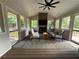 This sunroom boasts lots of natural light, comfortable seating, and a cozy fireplace at 747 Dogwood Cir, Norcross, GA 30071