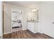 Bathroom leading into a bedroom with white cabinets and wood-look floors at 11113 Suria Dr, Covington, GA 30014