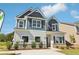 Charming two-story home featuring blue and white siding, complemented by well-manicured landscaping and bright, sunlit curb appeal at 11113 Suria Dr, Covington, GA 30014