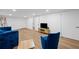 A sleek living room with plank floors, bright white walls, and blue velvet furniture at 2238 Pinecliff Ne Dr, Atlanta, GA 30345