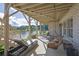 Enjoy a relaxing view of the lake from this back patio featuring a lounge chair, swing, and dining area at 4520 Odum Lake Trl, Cumming, GA 30040