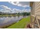 Stunning lake view from the backyard with manicured lawn and lush greenery, creating a peaceful oasis at 4520 Odum Lake Trl, Cumming, GA 30040