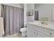 Neutral bathroom featuring a shower with curtain, white vanity, and an eye-catching piece of art at 4520 Odum Lake Trl, Cumming, GA 30040
