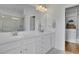 Elegant bathroom with double sinks, a large mirror, and a walk-in shower, creating a spa-like retreat at 4520 Odum Lake Trl, Cumming, GA 30040