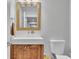 Stylish bathroom with a wood vanity, modern sink, and framed mirror at 4520 Odum Lake Trl, Cumming, GA 30040