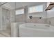 Luxurious bathroom with a corner soaking tub, glass-enclosed shower, and contemporary design elements at 4520 Odum Lake Trl, Cumming, GA 30040
