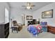 Cozy bedroom with ceiling fan, shelving unit, and comfortable chair, providing a relaxing space at 4520 Odum Lake Trl, Cumming, GA 30040