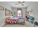 Bright bedroom with a colorful quilt, desk area, and natural light from the window at 4520 Odum Lake Trl, Cumming, GA 30040