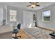 Bright bedroom featuring a Murphy bed, hardwood floors, and natural light from two windows at 4520 Odum Lake Trl, Cumming, GA 30040