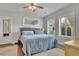 Bright bedroom with a comfortable bed, hardwood floors, and natural light streaming through the windows at 4520 Odum Lake Trl, Cumming, GA 30040