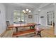Sunlit dining room featuring a large window, hardwood floors, and an ample table for Gathering gatherings at 4520 Odum Lake Trl, Cumming, GA 30040
