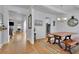 Bright dining room showcasing hardwood floors, a modern chandelier, and classic wainscoting details at 4520 Odum Lake Trl, Cumming, GA 30040