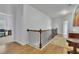 Bright hallway with hardwood floors and a view of the staircase, creating an inviting atmosphere at 4520 Odum Lake Trl, Cumming, GA 30040