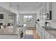 Modern kitchen showcasing white cabinetry, a granite-topped island, and stainless-steel appliances at 4520 Odum Lake Trl, Cumming, GA 30040