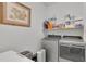 Functional laundry room with modern washer and dryer units and ample storage space at 4520 Odum Lake Trl, Cumming, GA 30040