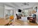 Bright, open living room boasts hardwood floors, a ceiling fan, and a large screen TV for entertainment at 4520 Odum Lake Trl, Cumming, GA 30040