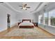 Spacious main bedroom featuring a tray ceiling, hardwood floors, and plenty of natural light at 4520 Odum Lake Trl, Cumming, GA 30040