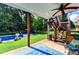 Covered back porch featuring a ceiling fan, staircase, and view of the pool and backyard at 2068 Tribble View Way, Lawrenceville, GA 30045