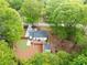 Aerial view showcasing a house with a deck, a shed, and a well-maintained yard surrounded by lush greenery at 2086 Harold Se Ave, Smyrna, GA 30080
