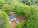 Lush landscape with mature trees surrounds the house and deck in this scenic aerial view at 2086 Harold Se Ave, Smyrna, GA 30080