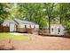 Wide angle of the backyard, featuring back buildings, a spacious deck, and trimmed grass at 2086 Harold Se Ave, Smyrna, GA 30080
