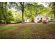 Expansive backyard featuring lush greenery, a charming outbuilding, and a cozy deck area, perfect for outdoor living at 2086 Harold Se Ave, Smyrna, GA 30080
