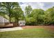 Wide angle of the backyard, featuring back buildings, a spacious deck, and trimmed grass at 2086 Harold Se Ave, Smyrna, GA 30080