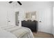 Well-lit bedroom featuring white linens, a dresser, ceiling fan, and access to the bathroom at 2086 Harold Se Ave, Smyrna, GA 30080