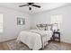 A light-filled bedroom with a white comforter, a neutral rug, and a bedside table at 2086 Harold Se Ave, Smyrna, GA 30080