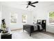 This bedroom is bright and airy, with three windows, a ceiling fan and a black bed frame at 2086 Harold Se Ave, Smyrna, GA 30080