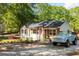 Charming single-story home with gravel driveway, landscaping, and light blue Bronco at 2086 Harold Se Ave, Smyrna, GA 30080
