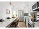 Well-lit kitchen with white cabinetry, stainless steel appliances, and a breakfast bar at 2086 Harold Se Ave, Smyrna, GA 30080