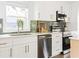 Updated kitchen with stainless steel appliances, white cabinets, and a view of the backyard from the window at 2086 Harold Se Ave, Smyrna, GA 30080