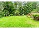 Large backyard features a well-maintained lawn and deck access, perfect for entertaining guests and enjoying the outdoors at 3156 Laurel Way, Snellville, GA 30078