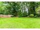 Lush green lawn with mature trees and landscaping, creating a serene and private outdoor oasis at 3156 Laurel Way, Snellville, GA 30078