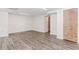 Spacious finished basement with wood-look floors and a wooden access door at 3156 Laurel Way, Snellville, GA 30078