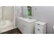 Bathroom with a double sink vanity, wood-look tile flooring, and a storage cabinet at 3156 Laurel Way, Snellville, GA 30078