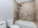 Tiled bathroom featuring a white bathtub with shower and modern fixtures at 3156 Laurel Way, Snellville, GA 30078