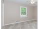 A cozy bedroom featuring neutral carpet, window, and a ceiling fan with overhead lighting at 3156 Laurel Way, Snellville, GA 30078