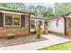 View of the front porch, showcasing the entrance, a window, and pleasant landscaping around the walkway at 3156 Laurel Way, Snellville, GA 30078