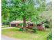 Charming ranch-style home boasting a brick exterior, attached garage, and a spacious front yard with mature trees at 3156 Laurel Way, Snellville, GA 30078