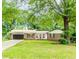 Charming single-story home featuring a brick facade, lush front lawn, and a convenient two-car garage at 3156 Laurel Way, Snellville, GA 30078