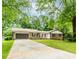 Beautiful brick home with attached garage, green lawn, and a welcoming front porch perfect for enjoying the outdoors at 3156 Laurel Way, Snellville, GA 30078