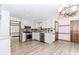 Well-lit kitchen featuring white cabinets and stainless steel appliances at 3156 Laurel Way, Snellville, GA 30078