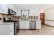 Well-equipped kitchen with stainless steel appliances and wood backsplash at 3156 Laurel Way, Snellville, GA 30078
