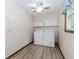 Practical laundry room with modern washer and dryer, plus overhead storage at 3156 Laurel Way, Snellville, GA 30078