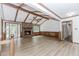 Cozy living space with hardwood floors, a brick fireplace, beamed ceilings, and access to the outdoors at 3156 Laurel Way, Snellville, GA 30078