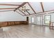 Expansive living room featuring wood floors, beamed ceilings, large windows and a traditional design at 3156 Laurel Way, Snellville, GA 30078